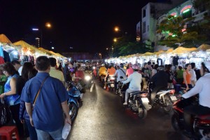 Mopeds making their way through the night market in Ho Chi Minh City